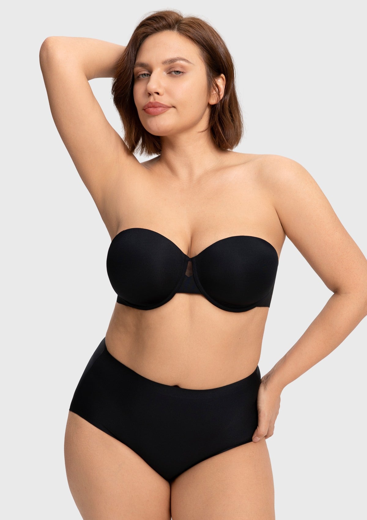 Confident woman raising her arms in the black strapless bra, showcasing the secure, non-slip grip of the most comfortable strapless bra that stays up effortlessly.