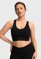 Close-up showing the high-stretch elastic band of the black Aura yoga bra for an inclusive comfortable fit