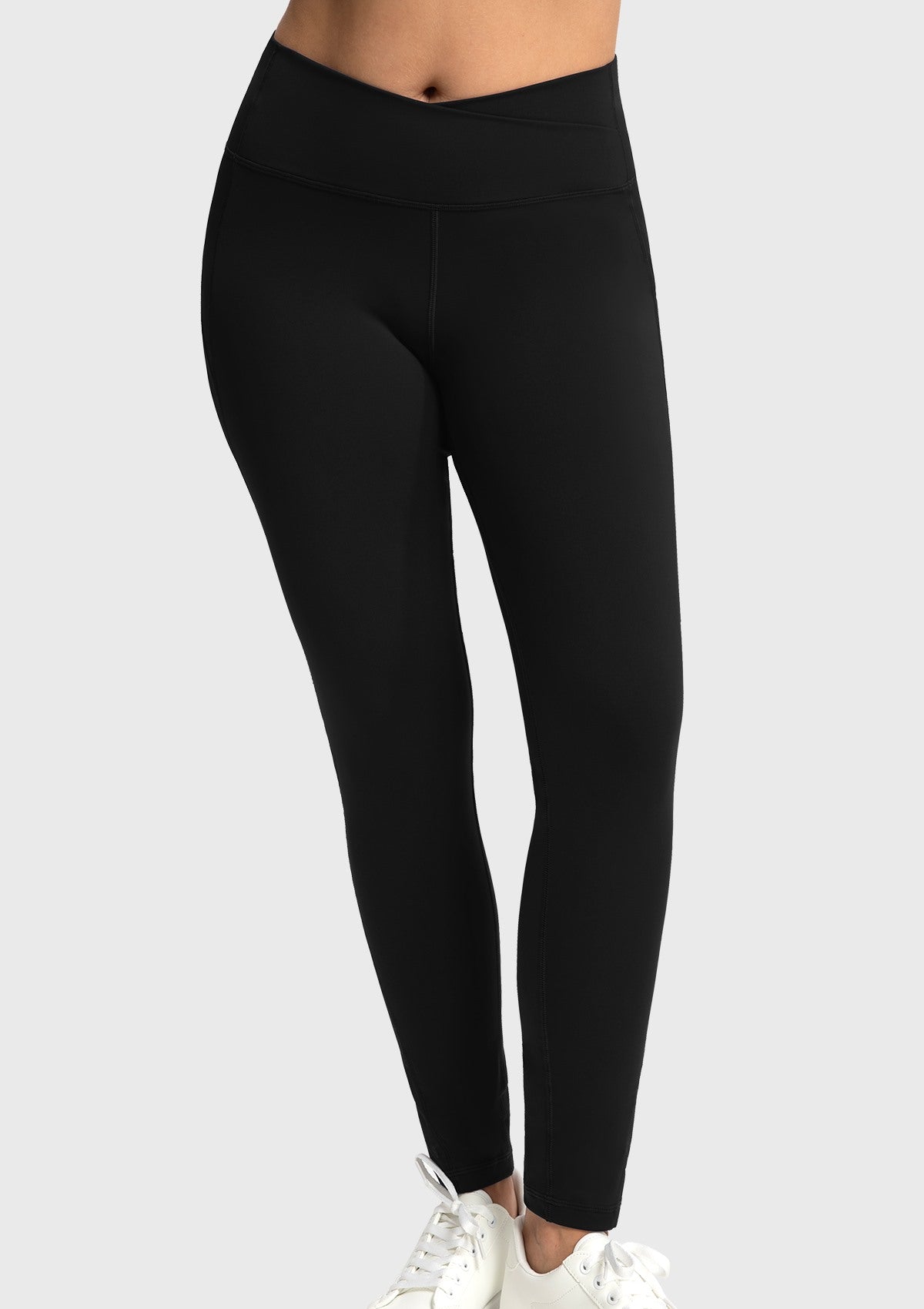 Front view of the black crossover high-waisted yoga pants, highlighting the stylish V-waist design that elegantly elongates the legs.
