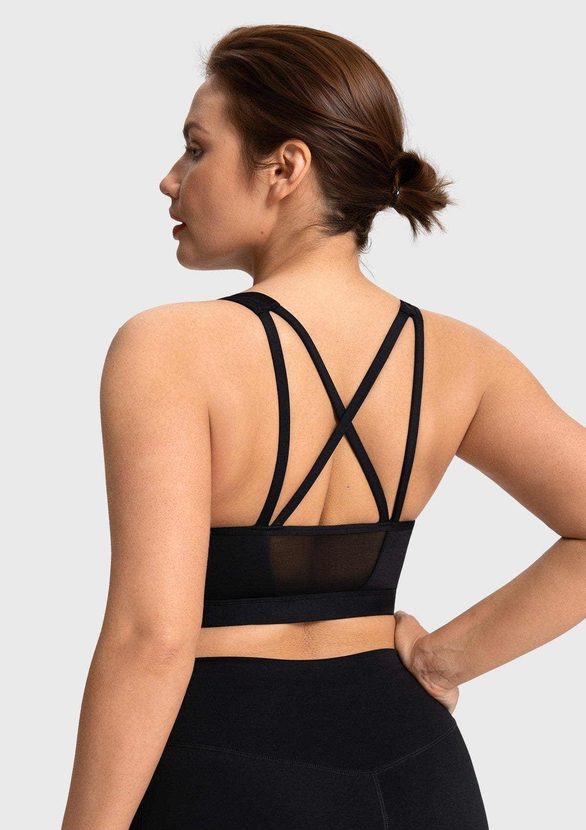 Back view highlighting the elegant double strappy design and breathable mesh on the black Aura bra