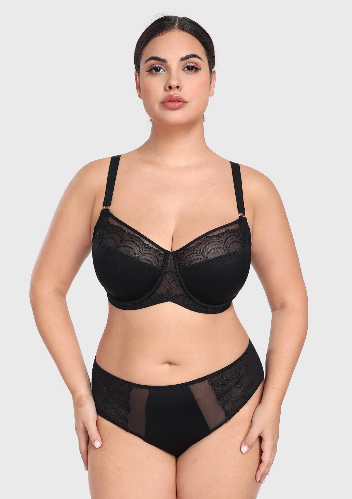 Woman posing confidently in the black French embroidery bra, demonstrating deep cup capacity and a flattering, open neckline without spillage.