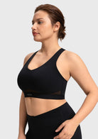 Side profile of the black Aura V-neck sports bra demonstrating full coverage and secure side support