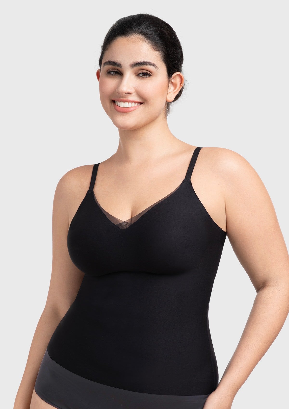Front view of the black Silvia seamless padded bra top, showcasing the elegant sheer mesh V-neck and buttery-soft fabric.