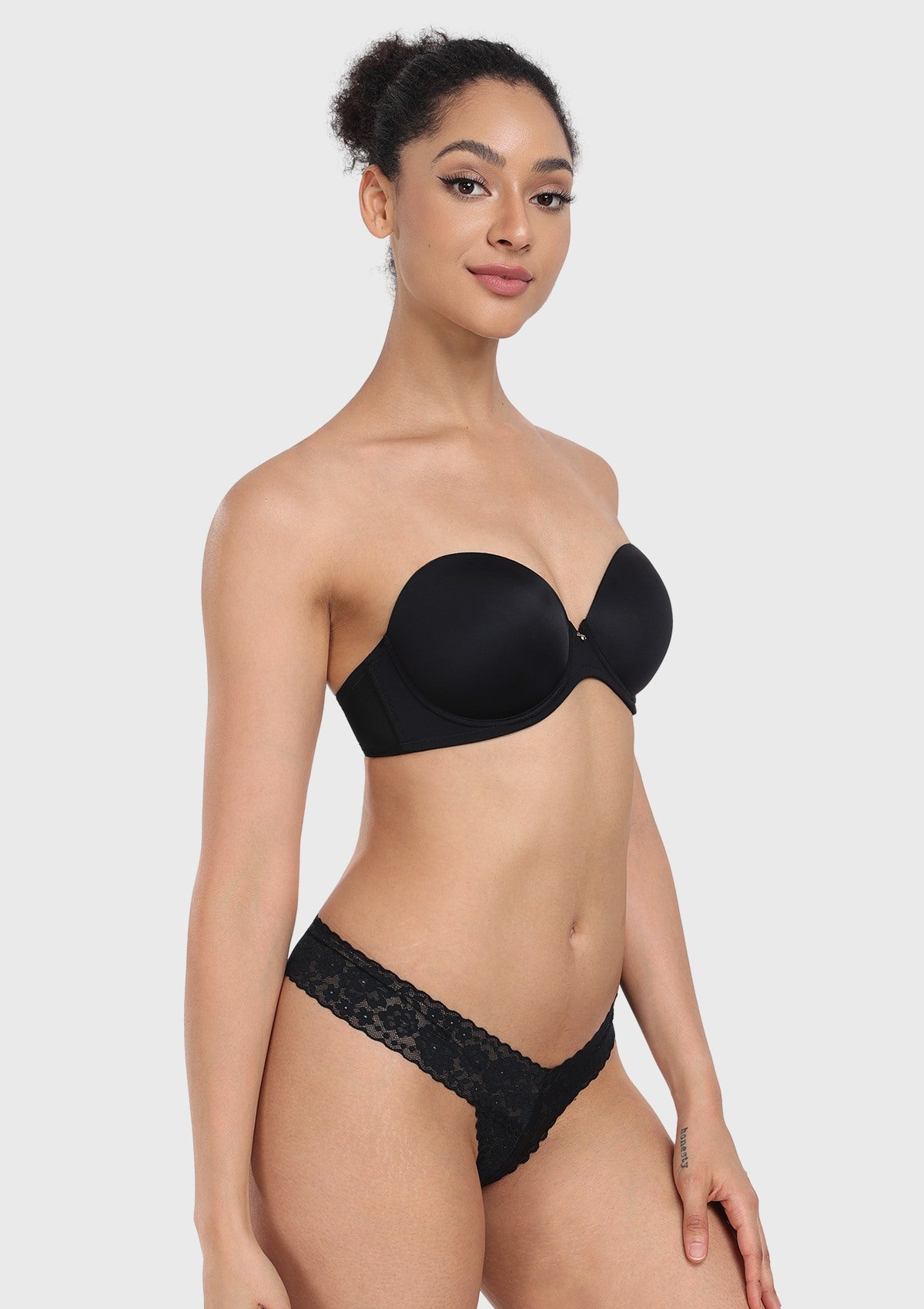 45-degree angle of the black strapless bra that stays up, highlighting the flexible side bones and medical-grade silicone grip.