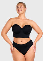 Woman wearing the black highly supportive strapless bra for large chest, enjoying gravity-defying lift and containment.