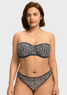 Front view of woman wearing the black and white leopard unlined strapless minimizer bra