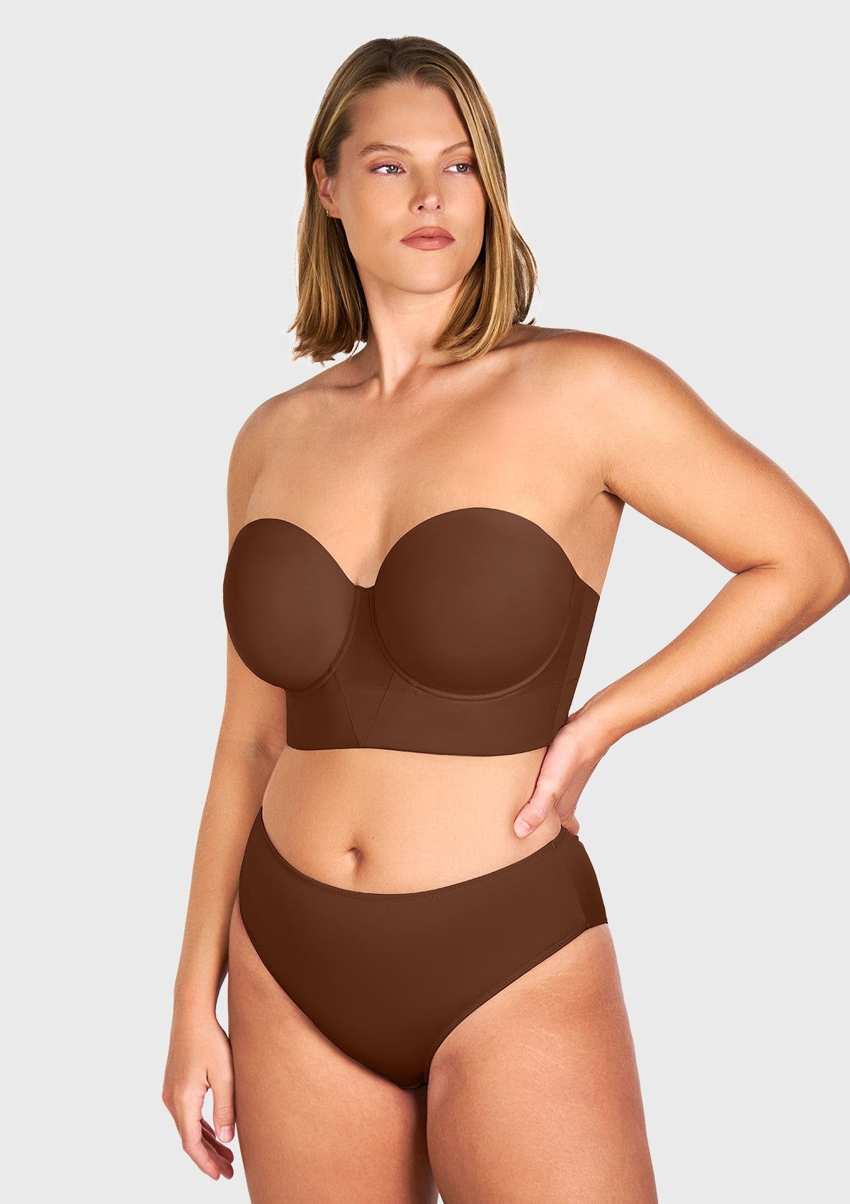  Front view highlighting the coffee brown seamless molded strapless bra, engineered with a smooth surface to lie flawlessly under the tightest dresses.