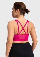Back view featuring the double criss-cross straps and back mesh splicing on the dragon fruit pink yoga bra