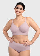 Model lifting arms in the gray purple Delia bra, demonstrating deep full-coverage cups that ensure secure containment.