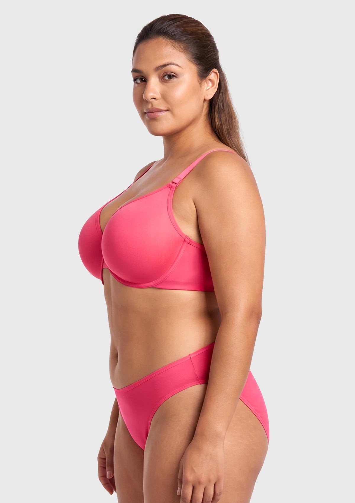 Side profile of model in the Knockout Pink Seraphina sheer mesh bra, showcasing the contoured cups and flexible underwire architecture that lifts without digging or spillage.