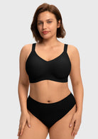 Close-up front view of the black wireless full coverage bra on model, highlighting the breathable, moisture-wicking stretch fabric that feels like a second skin.