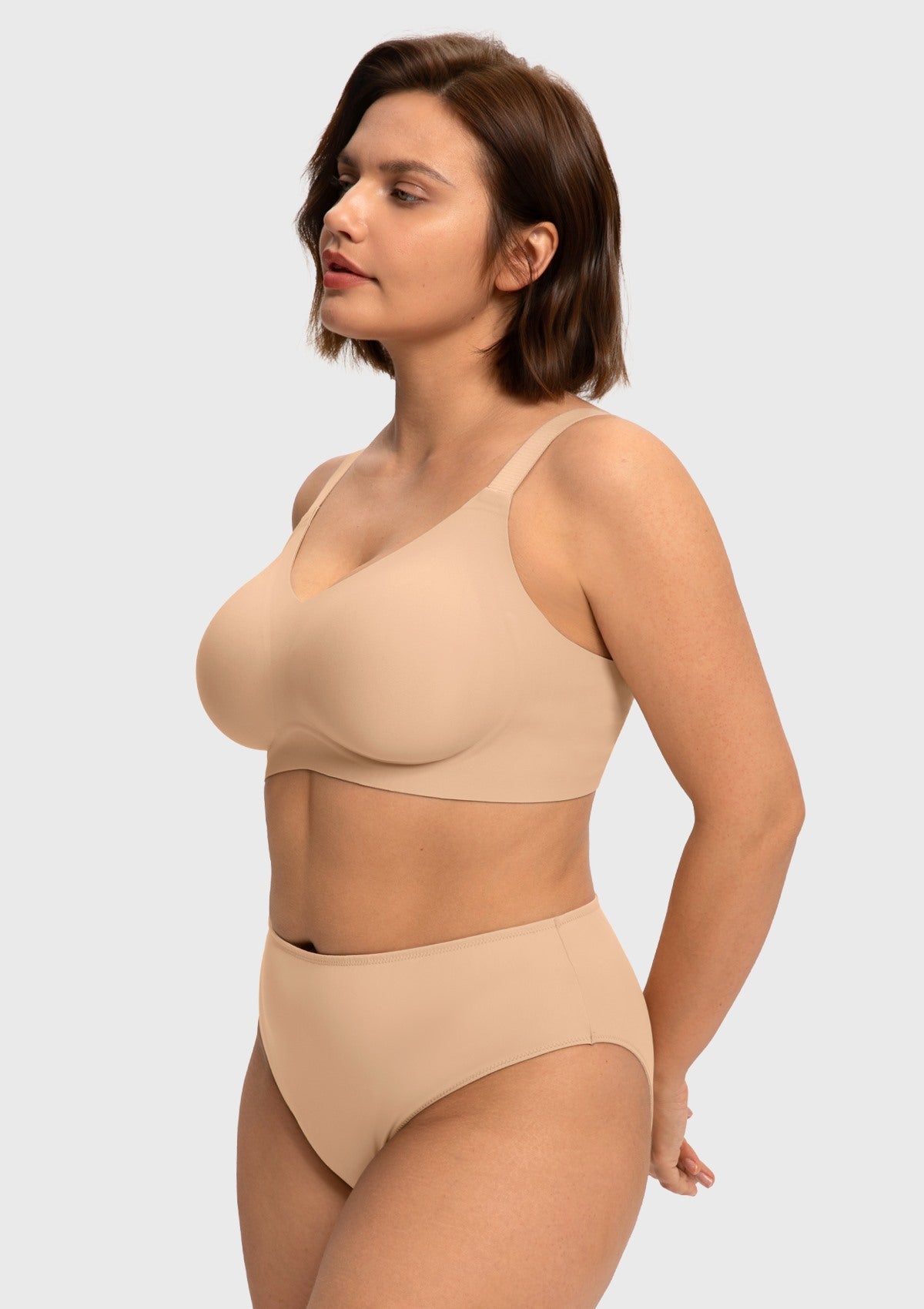 Side angle of the Light Beige SoftTouch jelly fit bra on model, demonstrating a stable hold and natural sculpting without the pressure of rigid wires.