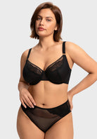 Front view of model in the black HSIA Yumi unlined bra, offering alluring sheer mesh with heavy-duty sculpting support for fuller figures.
