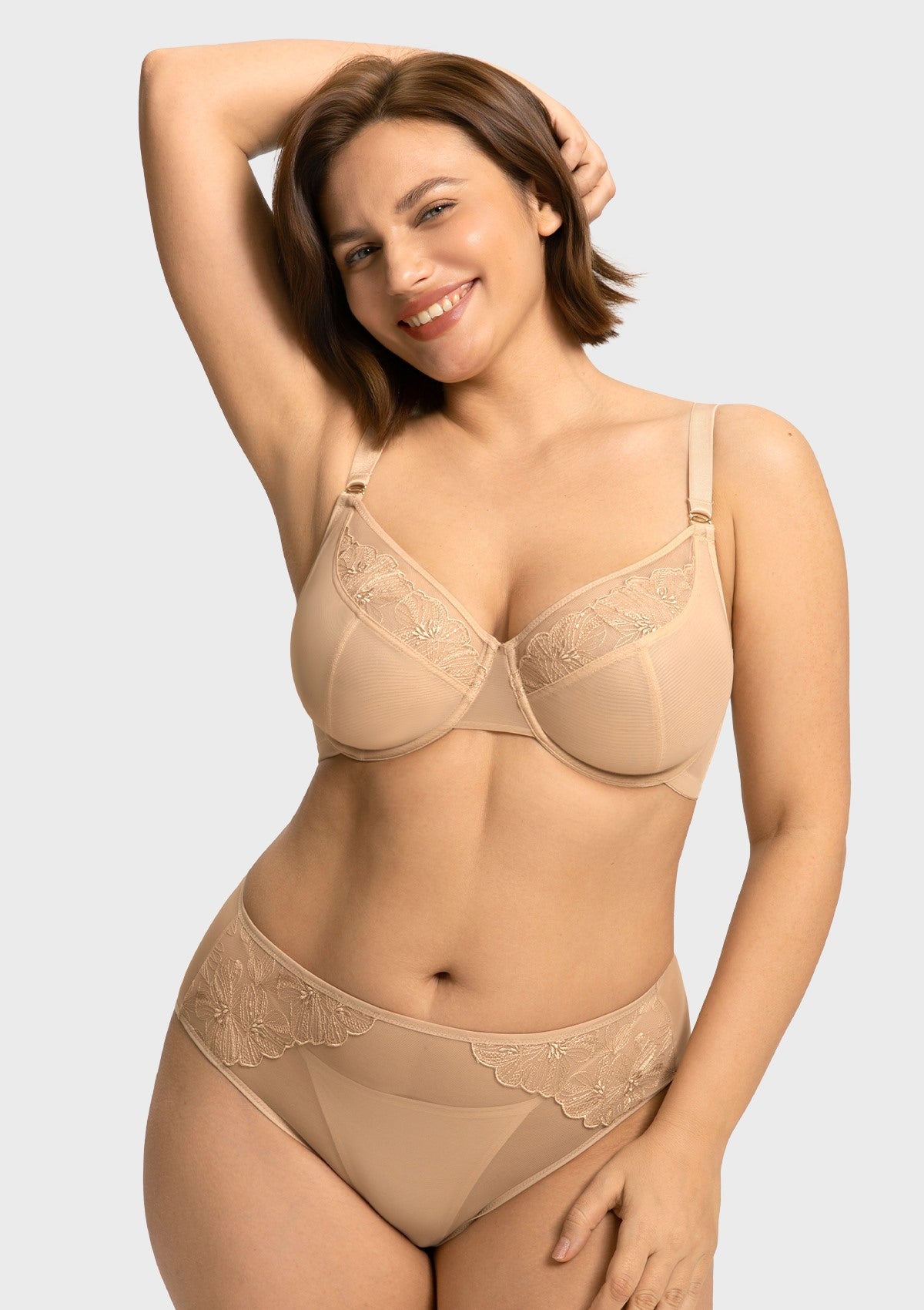 Model raising arms in the Light Beige Yumi bra, illustrating the comfortable high-stretch side wings and a secure fit for active days or busy commutes.