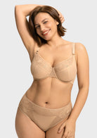 Model raising arms in the Light Beige Yumi bra, illustrating the comfortable high-stretch side wings and a secure fit for active days or busy commutes.