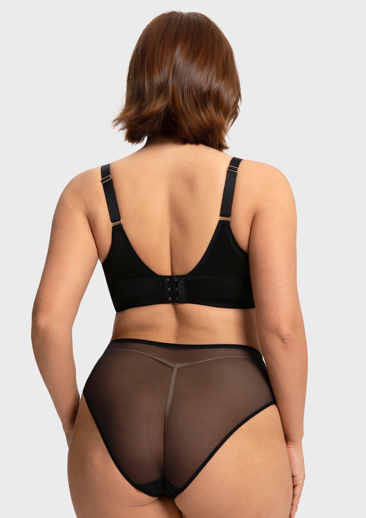 Rear view of the black Yumi unlined bra, displaying the secure multi-row hook closure and comfortable stretch wings that smooth the back silhouette.