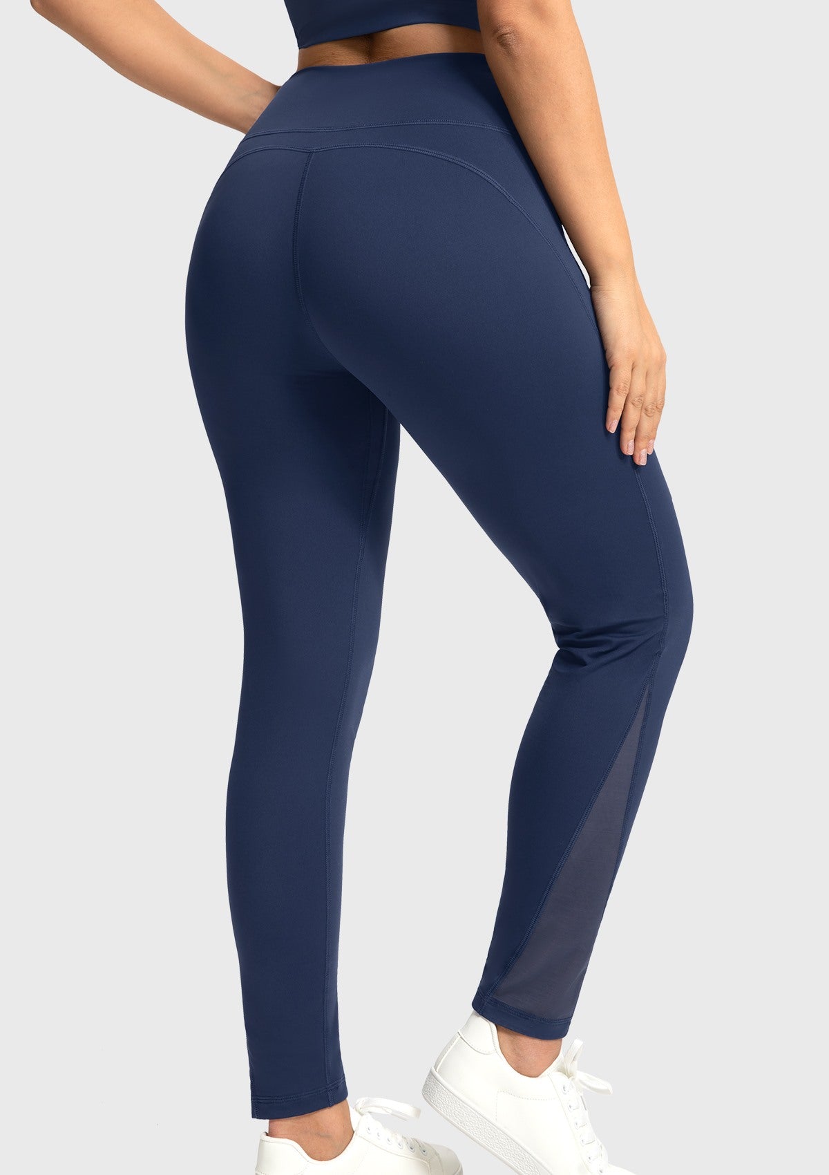 Rear view of the navy blue high-rise workout tights, delivering excellent glute coverage and a beautifully sculpted silhouette.