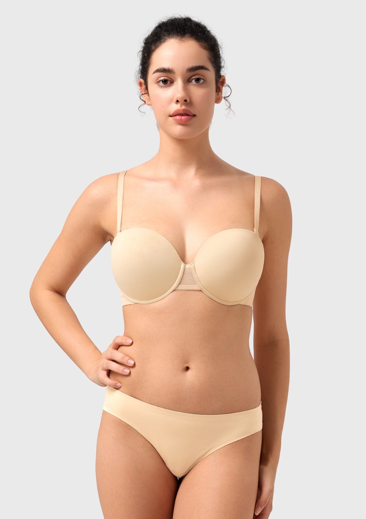 Woman raising her arms freely in the nude convertible push-up bra, highlighting the comfortable 4-way stretch fabric and secure fit.