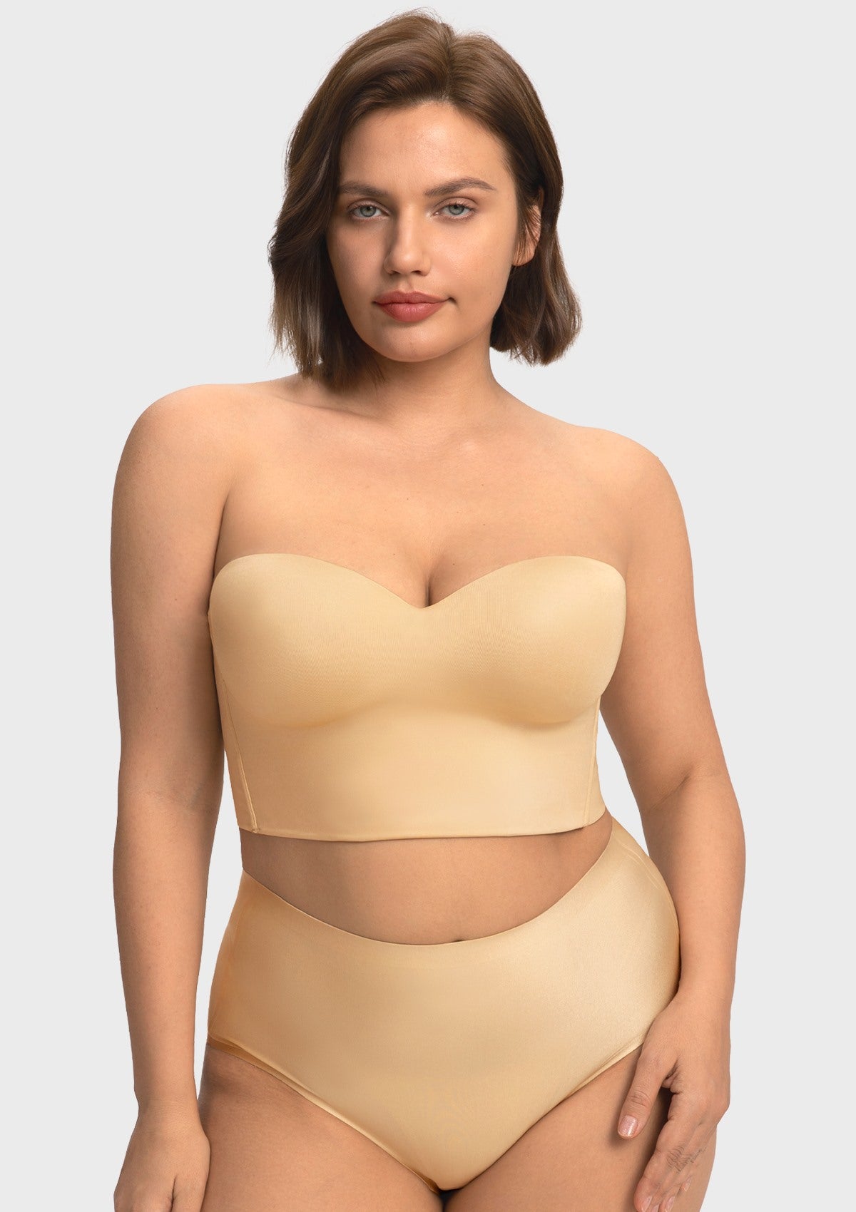  A confident woman wearing the nude supportive longline corset bra, styled effortlessly as an elegant standalone top.