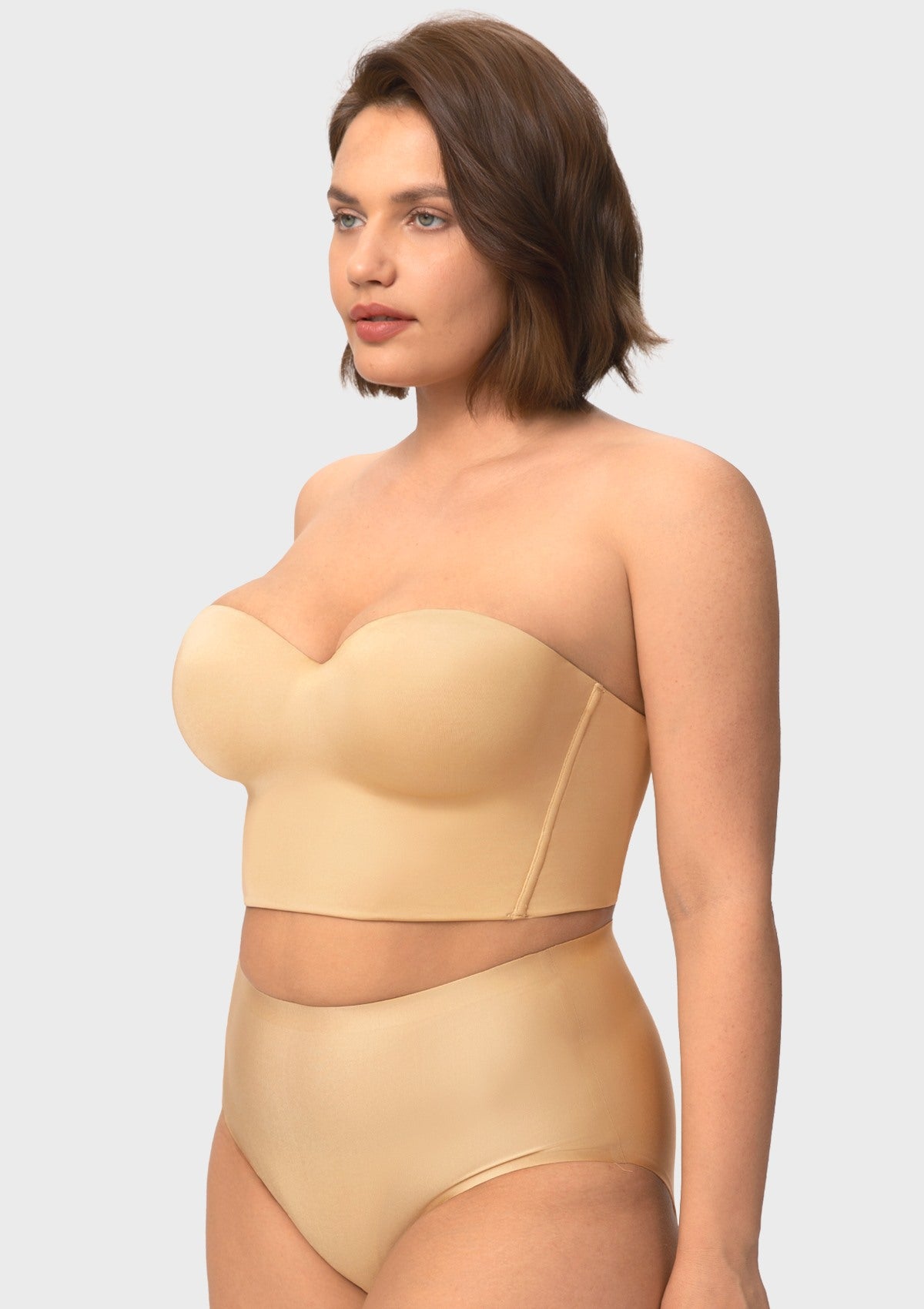 Three-quarter profile of the nude underwired strapless corset bra, highlighting beautiful lift, side containment, and natural shaping for large breasts.