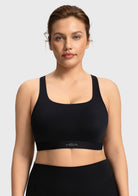 Front view of woman wearing the black Aura medium support cooling sports bra